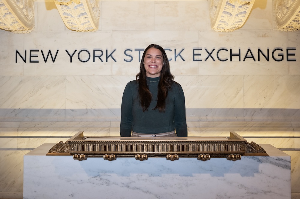 Woman standing in front of NYSE sign